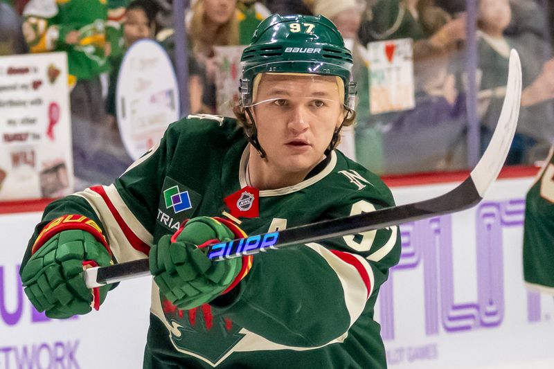 Nov 25, 2024; Saint Paul, Minnesota, USA;  Minnesota Wild forward Kirill Kaprizov (97) shoots a puck during warm up before a game against the Winnipeg Jets at Xcel Energy Center. Mandatory Credit: Nick Wosika-Imagn Images