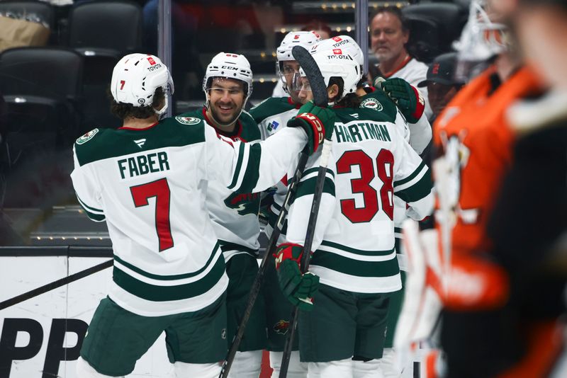 Nov 8, 2024; Anaheim, California, USA; Minnesota Wild left wing Marcus Foligno (17) celebrates with his teammates after scoring a goal during the first period of a hockey game against the Anaheim Ducks at Honda Center. Mandatory Credit: Jessica Alcheh-Imagn Images