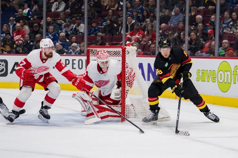 Feb 13, 2023; Vancouver, British Columbia, CAN; Detroit Red Wings defenseman Filip Hronek (17) and goalie Ville Husso (35) watch Vancouver Canucks forward Andrei Kuzmenko (96) handle the puck in the first period at Rogers Arena. Mandatory Credit: Bob Frid-USA TODAY Sports