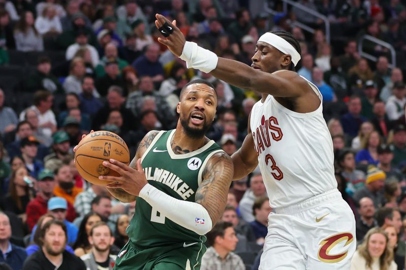 MILWAUKEE, WISCONSIN - JANUARY 24: Damian Lillard #0 of the Milwaukee Bucks is defended by Caris LeVert #3 of the Cleveland Cavaliers during a game at Fiserv Forum on January 24, 2024 in Milwaukee, Wisconsin. NOTE TO USER: User expressly acknowledges and agrees that, by downloading and or using this photograph, User is consenting to the terms and conditions of the Getty Images License Agreement. (Photo by Stacy Revere/Getty Images)