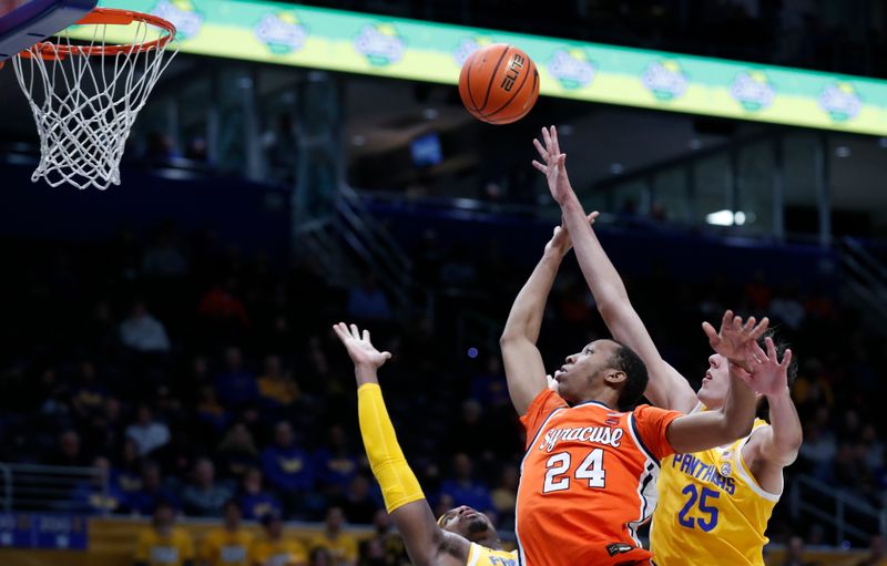 Jan 16, 2024; Pittsburgh, Pennsylvania, USA; Syracuse Orange guard Quadir Copeland (24) shoots against Pittsburgh Panthers forward Blake Hinson (left) and forward Guillermo Diaz Graham (25) during the first half at the Petersen Events Center. Mandatory Credit: Charles LeClaire-USA TODAY Sports