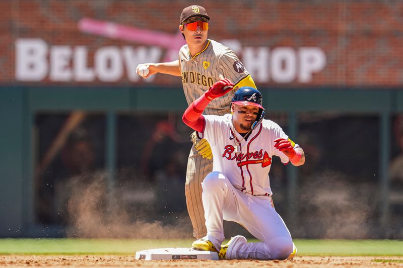 May 20, 2024; Cumberland, Georgia, USA; Atlanta Braves shortstop Orlando Arcia (11) is forced out by San Diego Padres shortstop Ha-Seong Kim (7) during the fourth inning at Truist Park. Mandatory Credit: Dale Zanine-USA TODAY Sports