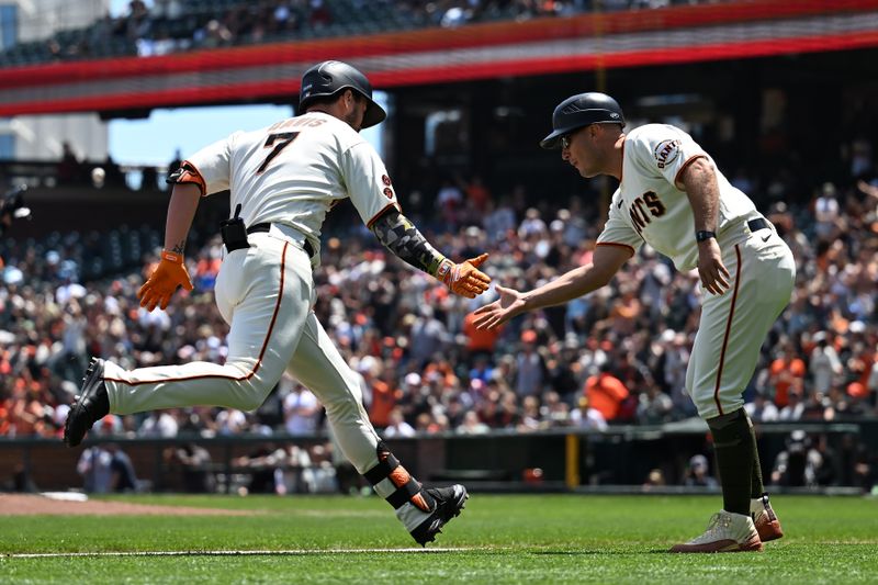 May 21, 2023; San Francisco, California, USA; San Francisco Giants designated hitter J.D. Davis (7) is greeted by third base coach Mark Hallberg (91) after hitting a solo home run against the Miami Marlins during the third inning at Oracle Park. Mandatory Credit: Robert Edwards-USA TODAY Sports