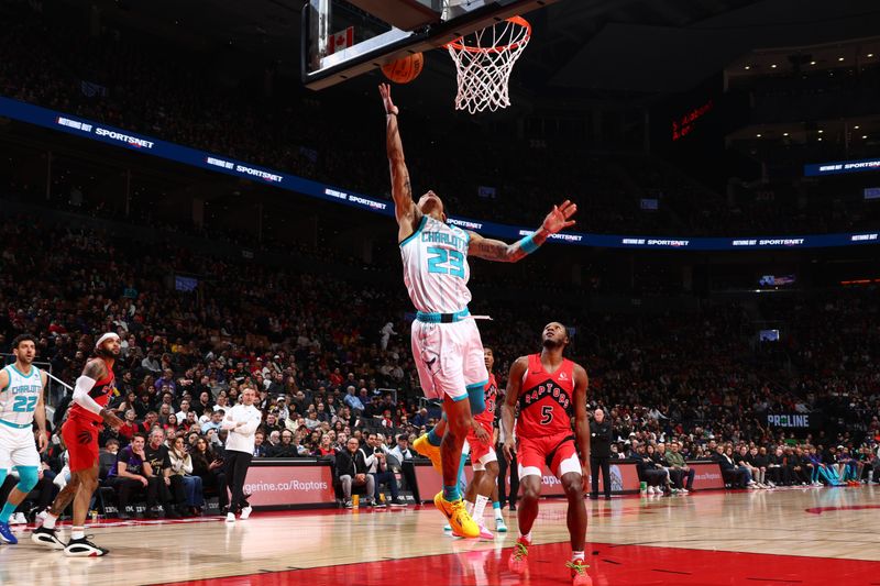 TORONTO, CANADA - MARCH 3: Tre Mann #23 of the Charlotte Hornets  drives to the basket during the game against the Toronto Raptors on March 3, 2024 at the Scotiabank Arena in Toronto, Ontario, Canada.  NOTE TO USER: User expressly acknowledges and agrees that, by downloading and or using this Photograph, user is consenting to the terms and conditions of the Getty Images License Agreement.  Mandatory Copyright Notice: Copyright 2024 NBAE (Photo by Vaughn Ridley/NBAE via Getty Images)