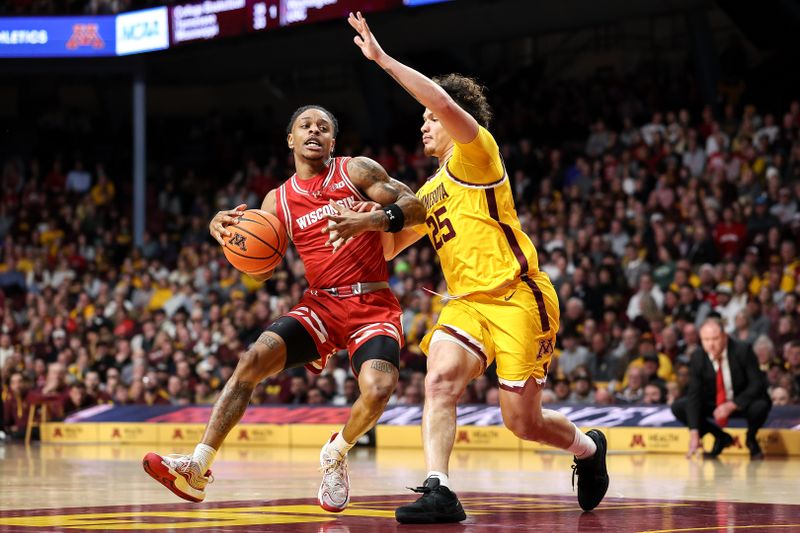 Mar 5, 2025; Minneapolis, Minnesota, USA; Wisconsin Badgers guard Kamari McGee (4) works around Minnesota Golden Gophers guard Lu'Cye Patterson (25) during the second half at Williams Arena. Mandatory Credit: Matt Krohn-Imagn Images