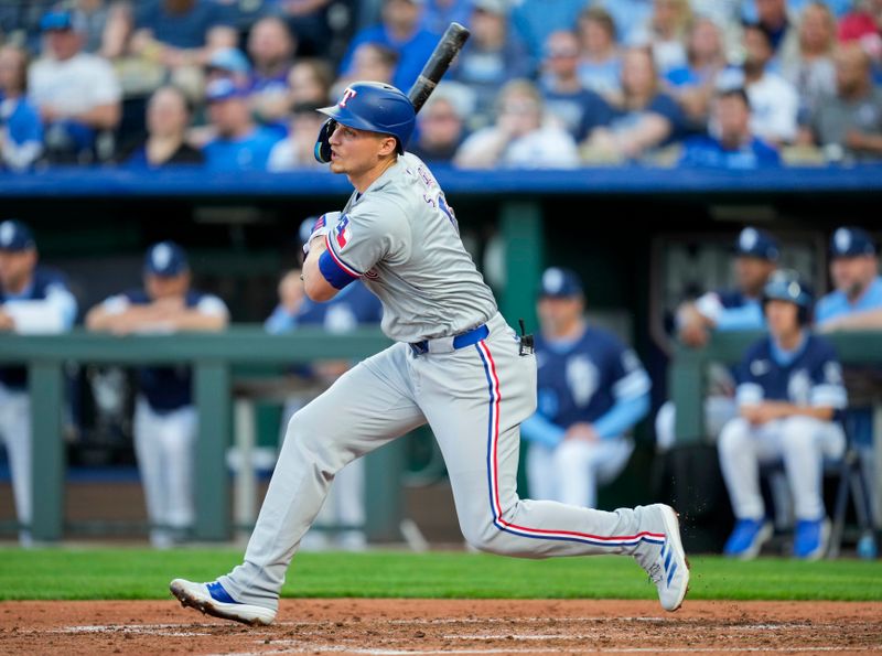 May 3, 2024; Kansas City, Missouri, USA; Texas Rangers shortstop Corey Seager (5) hits an RBI single during the third inning against the Kansas City Royals at Kauffman Stadium. Mandatory Credit: Jay Biggerstaff-USA TODAY Sports