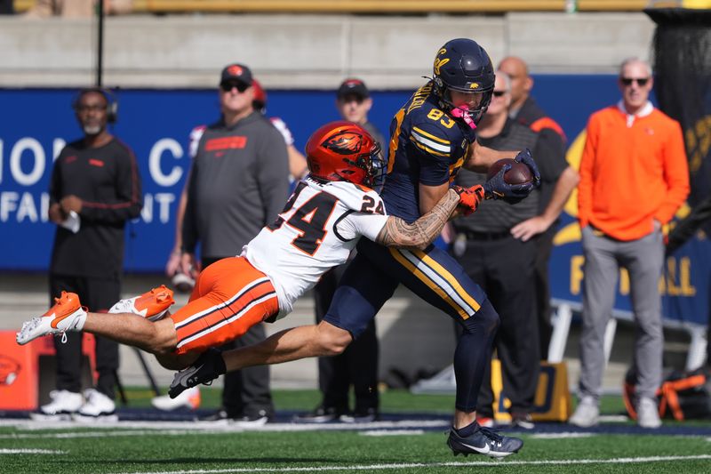 Oct 26, 2024; Berkeley, California, USA; California Golden Bears wide receiver Trond Grizzell (83) runs after a catch against Oregon State Beavers defensive back Jack Kane (24) during the first quarter at California Memorial Stadium. Mandatory Credit: Darren Yamashita-Imagn Images