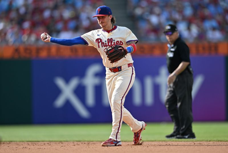 Jul 13, 2024; Philadelphia, Pennsylvania, USA; Philadelphia Phillies second baseman Bryson Stott (5) throws to first against the Oakland Athletics in the sixth inning at Citizens Bank Park. Mandatory Credit: Kyle Ross-USA TODAY Sports