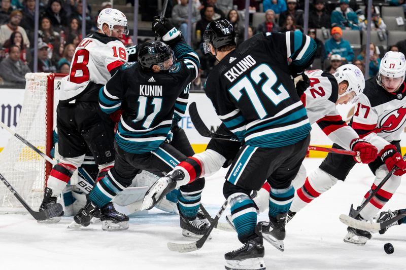 Feb 27, 2024; San Jose, California, USA;  San Jose Sharks center Nico Sturm (7) and New Jersey Devils left wing Ondrej Palat (18) battle for position in front of the net during the first period at SAP Center at San Jose. Mandatory Credit: Neville E. Guard-USA TODAY Sports