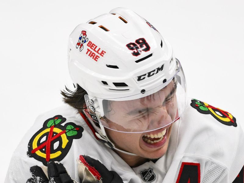 Dec 12, 2025; St. Louis, Missouri, USA; Chicago Blackhawks center Connor Bedard (98) reacts in pain after a face off against St. Louis Blues center Brayden Schenn (not pictured) during the third period at Enterprise Center. Mandatory Credit: Jeff Curry-Imagn Images