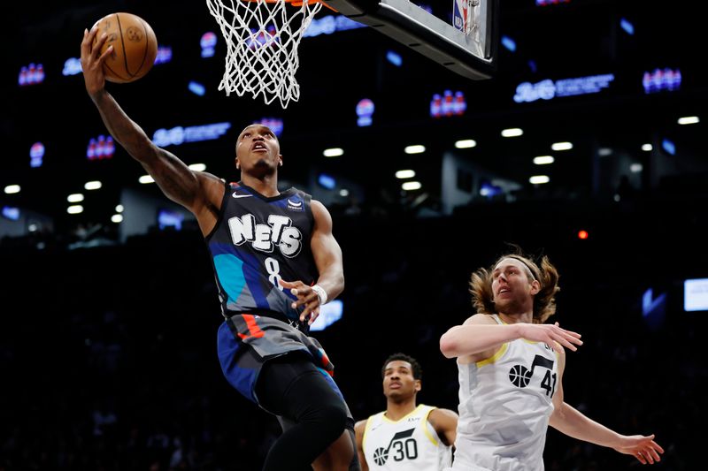 NEW YORK, NEW YORK - JANUARY 29: Lonnie Walker IV #8 of the Brooklyn Nets goes to the basket as Kelly Olynyk #41 of the Utah Jazz defends during the second half at Barclays Center on January 29, 2024 in the Brooklyn borough of New York City. The Nets won 147-114. NOTE TO USER: User expressly acknowledges and agrees that, by downloading and/or using this Photograph, user is consenting to the terms and conditions of the Getty Images License Agreement. (Photo by Sarah Stier/Getty Images)