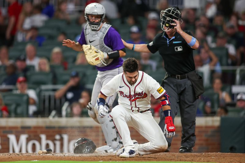 Sep 3, 2024; Atlanta, Georgia, USA; Atlanta Braves second baseman Whit Merrifield (15) falls to the ground after being hit in the head with a pitch against the Colorado Rockies in the seventh inning at Truist Park. Mandatory Credit: Brett Davis-Imagn Images 
