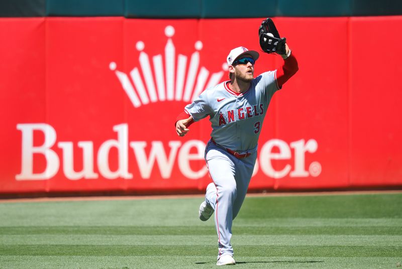 Jul 4, 2024; Oakland, California, USA; Los Angeles Angels left fielder Taylor Ward (3) catches the ball against the Oakland Athletics during the sixth inning at Oakland-Alameda County Coliseum. Mandatory Credit: Kelley L Cox-USA TODAY Sports