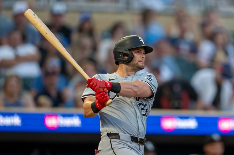 Aug 2, 2024; Minneapolis, Minnesota, USA; Chicago White Sox left fielder Andrew Benintendi (23) hits a single against the Minnesota Twins in the fourth inning at Target Field. Mandatory Credit: Jesse Johnson-USA TODAY Sports