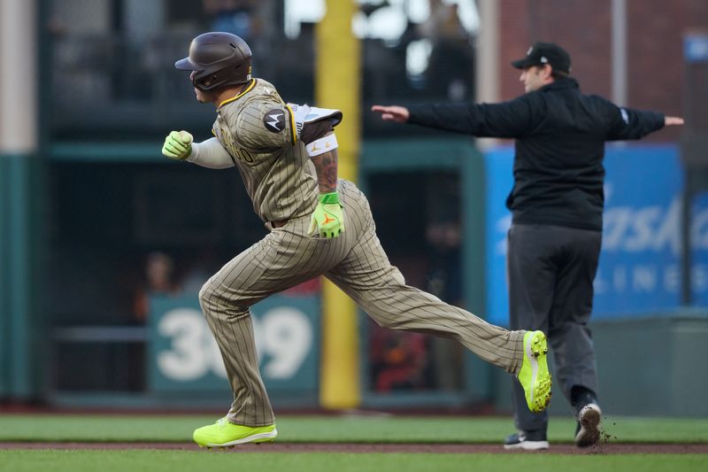 Sep 14, 2024; San Francisco, California, USA; San Diego Padres infielder Manny Machado (13) runs to second base after hitting a double against the San Francisco Giants during the first inning at Oracle Park. Mandatory Credit: Robert Edwards-Imagn Images