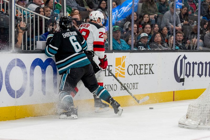 Feb 27, 2024; San Jose, California, USA;  New Jersey Devils right wing Timo Meier (28) is checked into the boards by San Jose Sharks defenseman Ty Emberson (6) during the first period at SAP Center at San Jose. Mandatory Credit: Neville E. Guard-USA TODAY Sports