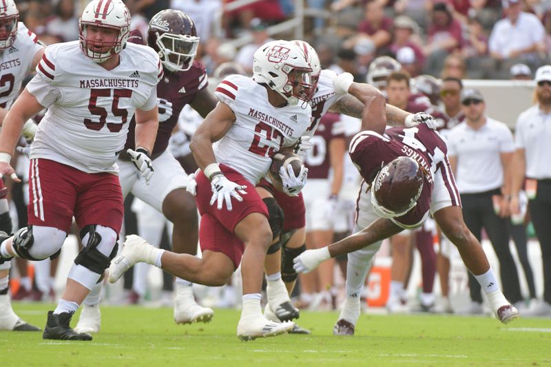 Nov 2, 2024; Starkville, Mississippi, USA; Massachusetts Minutemen running back Brandon Campbell (23) runs the ball against the Mississippi State Bulldogs during the first quarter at Davis Wade Stadium at Scott Field. Mandatory Credit: Matt Bush-Imagn Images