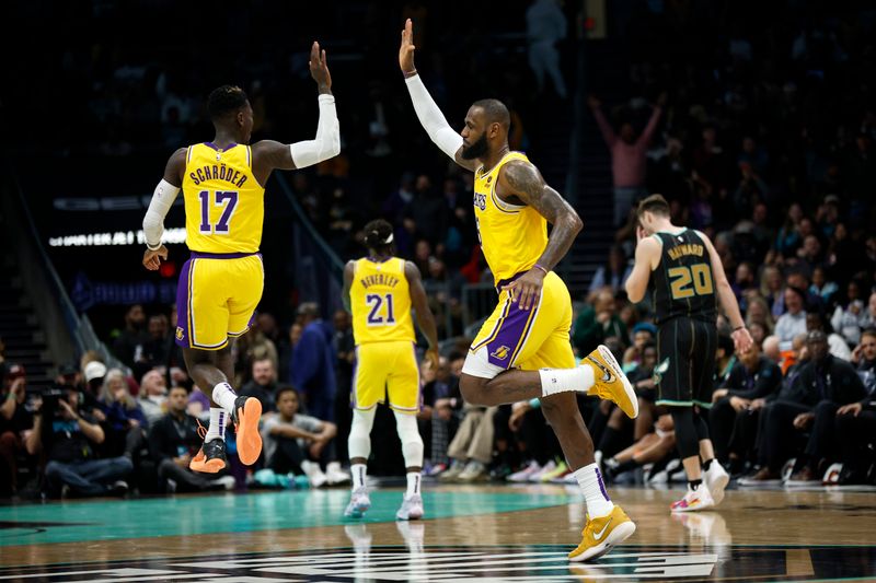 CHARLOTTE, NORTH CAROLINA - JANUARY 02: LeBron James #6 of the Los Angeles Lakers reacts with teammate Dennis Schroder #17 following a dunk during the second half of the game against the Charlotte Hornets at Spectrum Center on January 02, 2023 in Charlotte, North Carolina. NOTE TO USER: User expressly acknowledges and agrees that, by downloading and or using this photograph, User is consenting to the terms and conditions of the Getty Images License Agreement. (Photo by Jared C. Tilton/Getty Images)