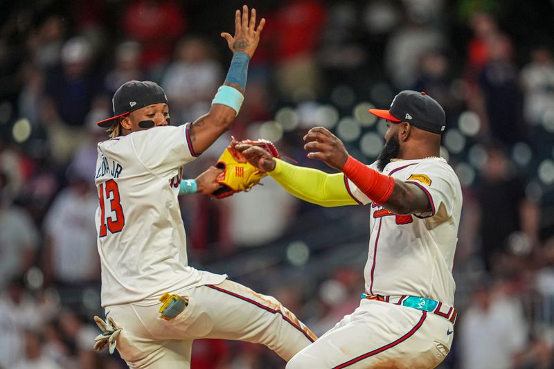 May 20, 2024; Cumberland, Georgia, USA; Atlanta Braves right fielder Ronald Acuna Jr (13) and designated hitter Marcell Ozuna (20) react after the Braves defeated the San Diego Padres at Truist Park.Mandatory Credit: Dale Zanine-USA TODAY Sports