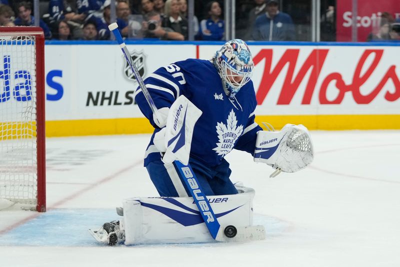 Oct 24, 2024; Toronto, Ontario, CAN; Toronto Maple Leafs goaltender Joseph Woll (60) makes a save against the St. Louis Blues during the second period at Scotiabank Arena. Mandatory Credit: John E. Sokolowski-Imagn Images