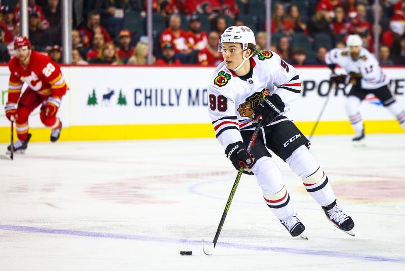 Oct 15, 2024; Calgary, Alberta, CAN; Chicago Blackhawks center Connor Bedard (98) skates with the puck against the Calgary Flames during the first period at Scotiabank Saddledome. Mandatory Credit: Sergei Belski-Imagn Images