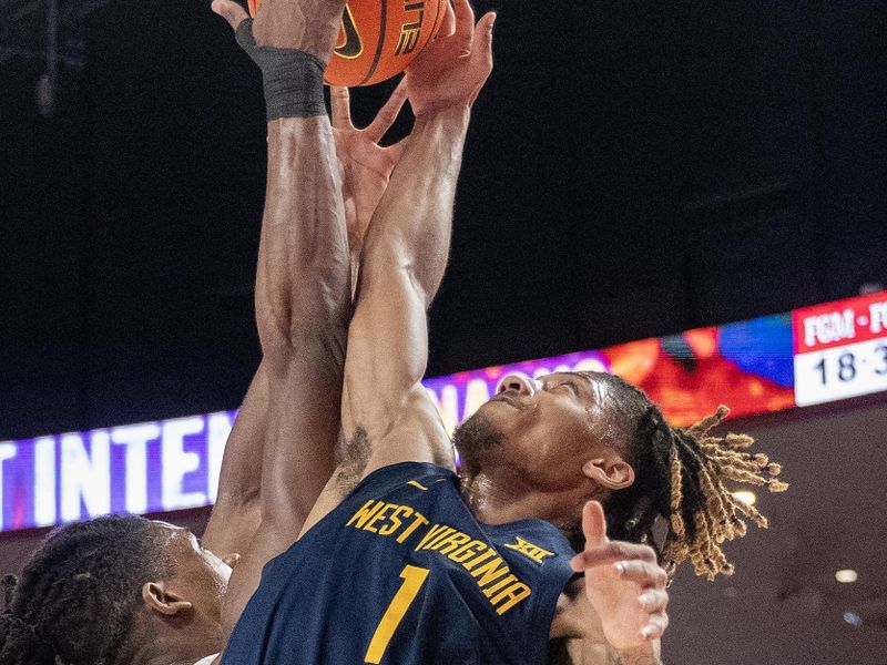 Jan 6, 2024; Houston, Texas, USA; West Virginia Mountaineers guard Noah Farrakhan (1) and Houston Cougars forward Joseph Tugler (25) reach for a rebound in the first half  at Fertitta Center. Mandatory Credit: Thomas Shea-USA TODAY Sports