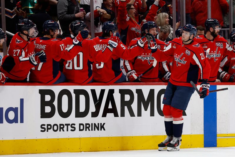 May 6, 2025; Washington, District of Columbia, USA; Washington Capitals center Aliaksei Protas (21) celebrates with teammates after scoring a goal against the Carolina Hurricanes in the second period in game one of the second round of the 2025 Stanley Cup Playoffs at Capital One Arena. Mandatory Credit: Geoff Burke-Imagn Images