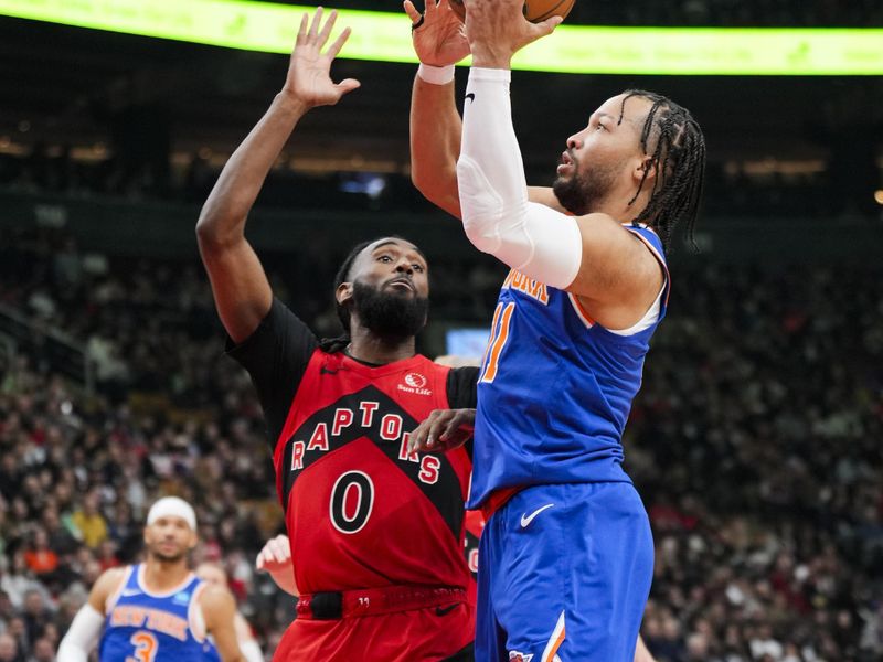 TORONTO, ON - MARCH 27: Jalen Brunson #11 of the New York Knicks shoots against Javon Freeman-Liberty #0 of the Toronto Raptors during the first half of their basketball game at the Scotiabank Arena on March 27, 2024 in Toronto, Ontario, Canada. NOTE TO USER: User expressly acknowledges and agrees that, by downloading and/or using this Photograph, user is consenting to the terms and conditions of the Getty Images License Agreement. (Photo by Mark Blinch/Getty Images)