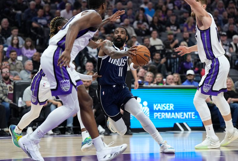 SACRAMENTO, CALIFORNIA - MARCH 29: Kyrie Irving #11 of the Dallas Mavericks drives to the basket on Keon Ellis #23 and Harrison Barnes #40 of the Sacramento Kings during the first half at Golden 1 Center on March 29, 2024 in Sacramento, California. NOTE TO USER: User expressly acknowledges and agrees that, by downloading and or using this photograph, User is consenting to the terms and conditions of the Getty Images License Agreement. (Photo by Thearon W. Henderson/Getty Images)