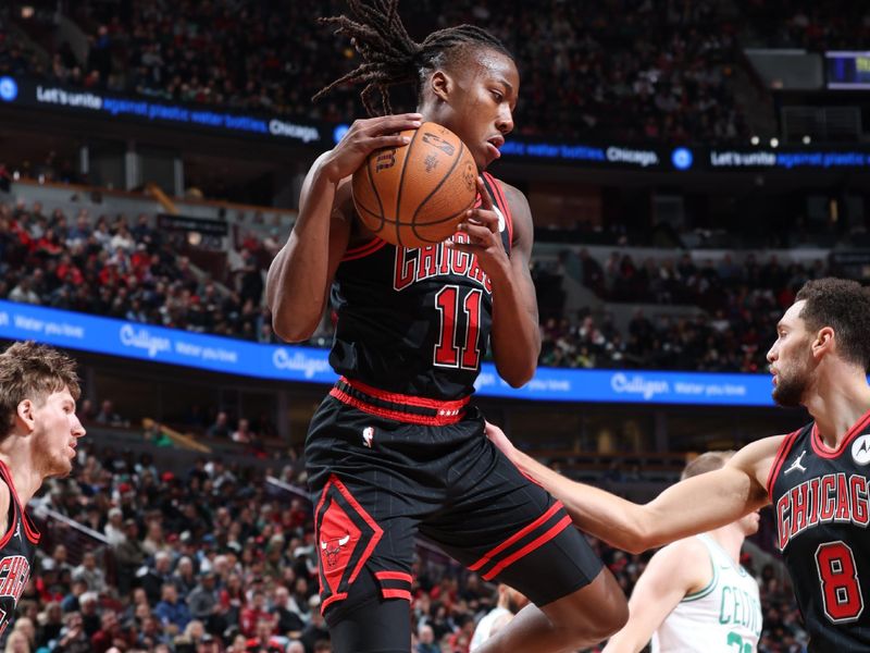 CHICAGO, IL - NOVEMBER 29: Ayo Dosunmu #11 of the Chicago Bulls rebounds the ball during the game against the Boston Celtics during the Emirates NBA Cup game on November 29, 2024 at United Center in Chicago, Illinois. NOTE TO USER: User expressly acknowledges and agrees that, by downloading and or using this photograph, User is consenting to the terms and conditions of the Getty Images License Agreement. Mandatory Copyright Notice: Copyright 2024 NBAE (Photo by Jeff Haynes/NBAE via Getty Images)