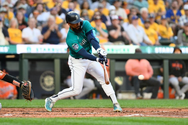 Aug 12, 2023; Seattle, Washington, USA; Seattle Mariners right fielder Teoscar Hernandez (35) hits a single against the Baltimore Orioles during the fourth inning at T-Mobile Park. Mandatory Credit: Steven Bisig-USA TODAY Sports