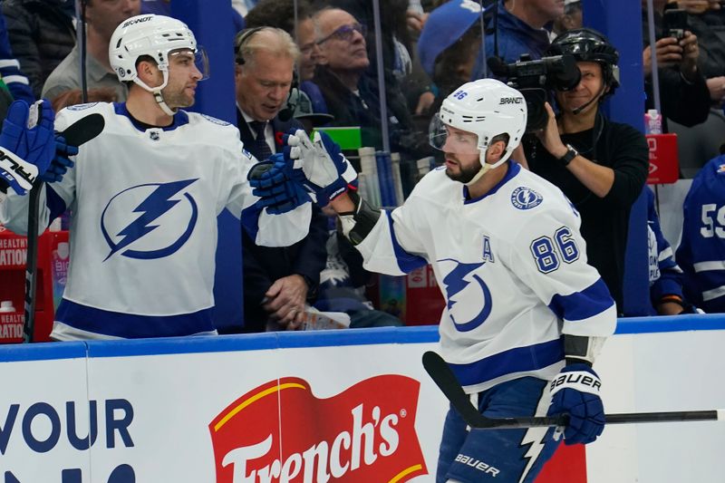 Nov 6, 2023; Toronto, Ontario, CAN; Tampa Bay Lightning forward Nikita Kucherov (86) gets congratulated after scoring aginst the Toronto Maple Leafs during the first period at Scotiabank Arena. Mandatory Credit: John E. Sokolowski-USA TODAY Sports