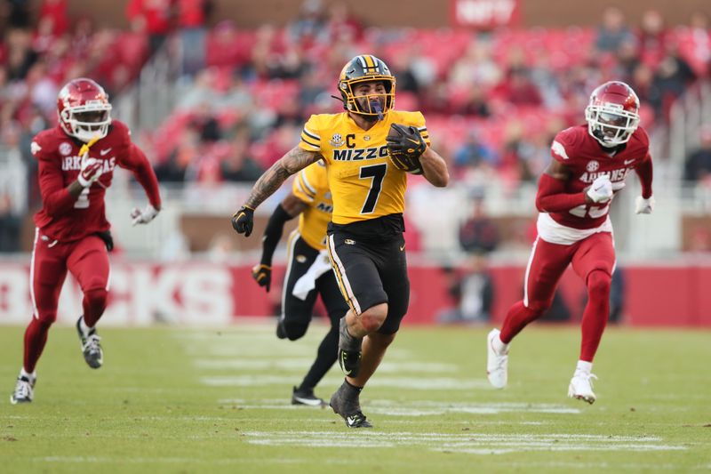 Nov 24, 2023; Fayetteville, Arkansas, USA; Missouri Tigers running back Cody Schrader (7) rushes against the Arkansas Razorbacks during the second quarter at Donald W. Reynolds Razorback Stadium. Mandatory Credit: Nelson Chenault-USA TODAY Sports