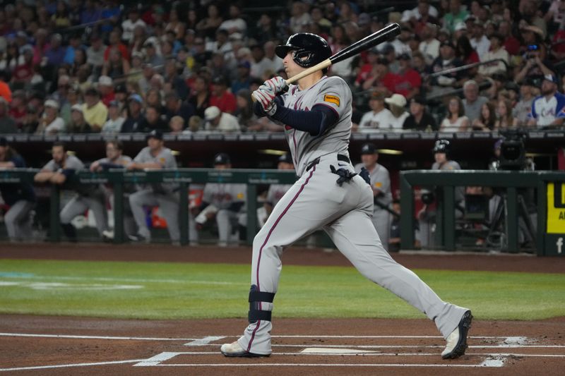 Apr 27, 2025; Phoenix, Arizona, USA; Atlanta Braves third base Austin Riley (27) hits a double against the Arizona Diamondbacks in the first inning at Chase Field. Mandatory Credit: Rick Scuteri-Imagn Images