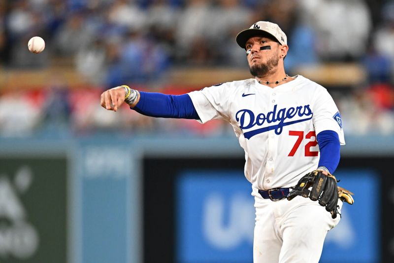 May 17, 2025; Los Angeles, California, USA; Los Angeles Dodgers second baseman Miguel Rojas (72) fields a ball against the Los Angeles Angels during the eighth inning at Dodger Stadium. Mandatory Credit: Jonathan Hui-Imagn Images