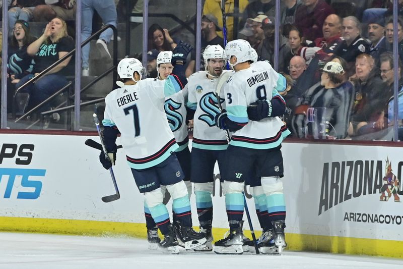 Nov 7, 2023; Tempe, Arizona, USA; Seattle Kraken defenseman Justin Schultz (4) celebrates with teammates after scoring a goal in the second period against the Arizona Coyotes at Mullett Arena. Mandatory Credit: Matt Kartozian-USA TODAY Sports