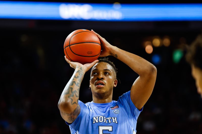 Feb 19, 2023; Raleigh, North Carolina, USA; North Carolina Tar Heels forward Armando Bacot (5) shoots a free throw during the second half of the game against North Carolina State Wolfpack at PNC Arena. Mandatory Credit: Jaylynn Nash-USA TODAY Sports