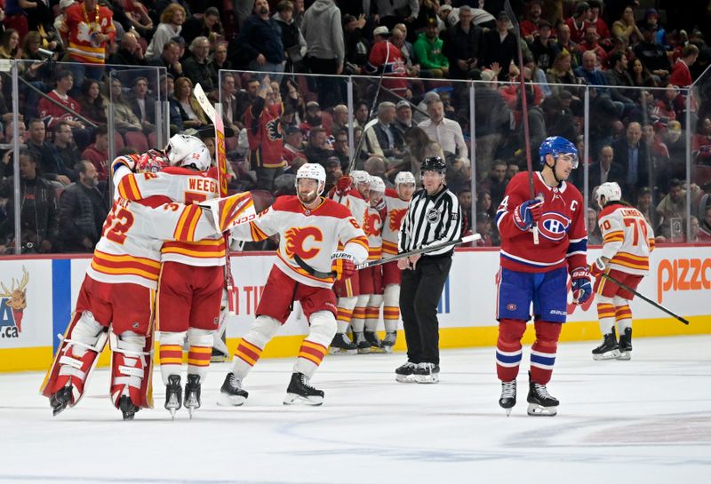 Nov 5, 2024; Montreal, Quebec, CAN; The Calagary Flames celebrate the win against the Montreal Canadiens during the overtime period at the Bell Centre. Mandatory Credit: Eric Bolte-Imagn Images