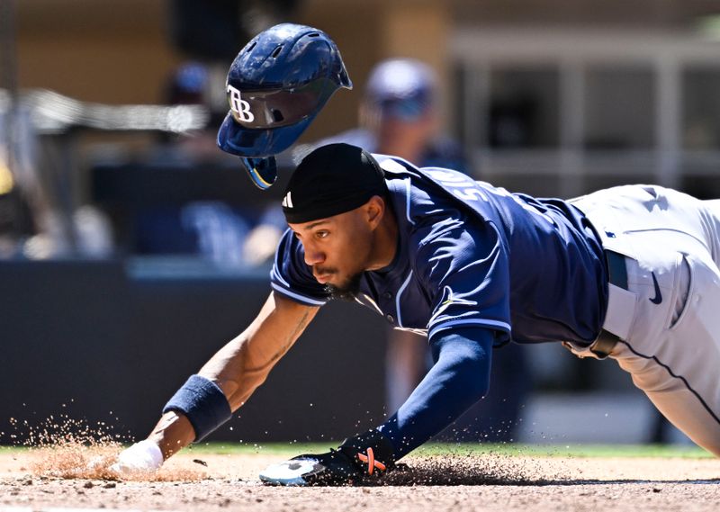 Apr 27, 2025; San Diego, California, USA; Tampa Bay Rays shortstop Chandler Simpson (14) dives to score on a wild pitch during the fifth inning against the San Diego Padres at Petco Park. Mandatory Credit: Denis Poroy-Imagn Images