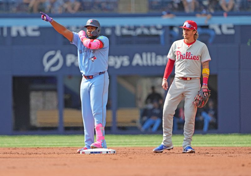 Sep 4, 2024; Toronto, Ontario, CAN; Toronto Blue Jays third baseman Vladimir Guerrero Jr. (27) celebrates hitting an RBI double against the Philadelphia Phillies during the first inning at Rogers Centre. Mandatory Credit: Nick Turchiaro-Imagn Images