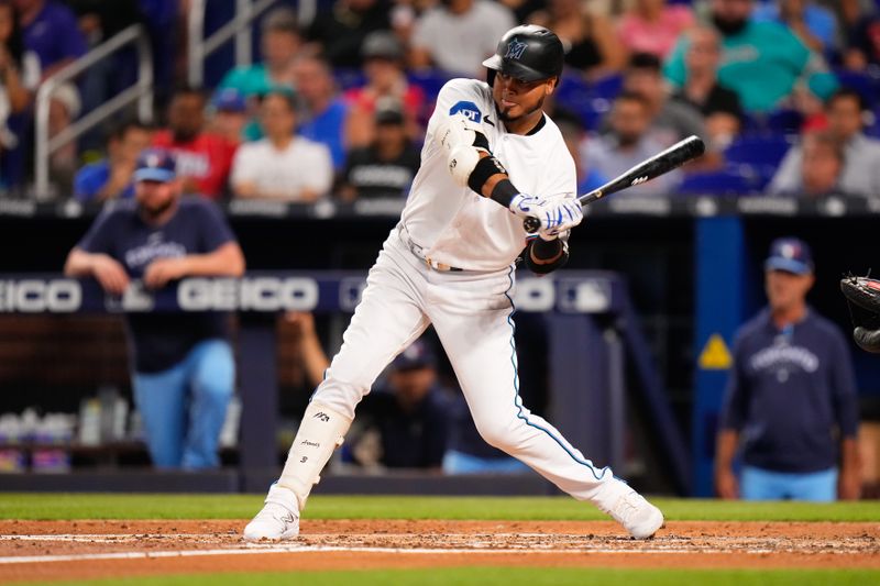 Jun 20, 2023; Miami, Florida, USA; Miami Marlins second baseman Luis Arraez (3) hits a single against the Toronto Blue Jays during the fourth inning at loanDepot Park. Mandatory Credit: Rich Storry-USA TODAY Sports