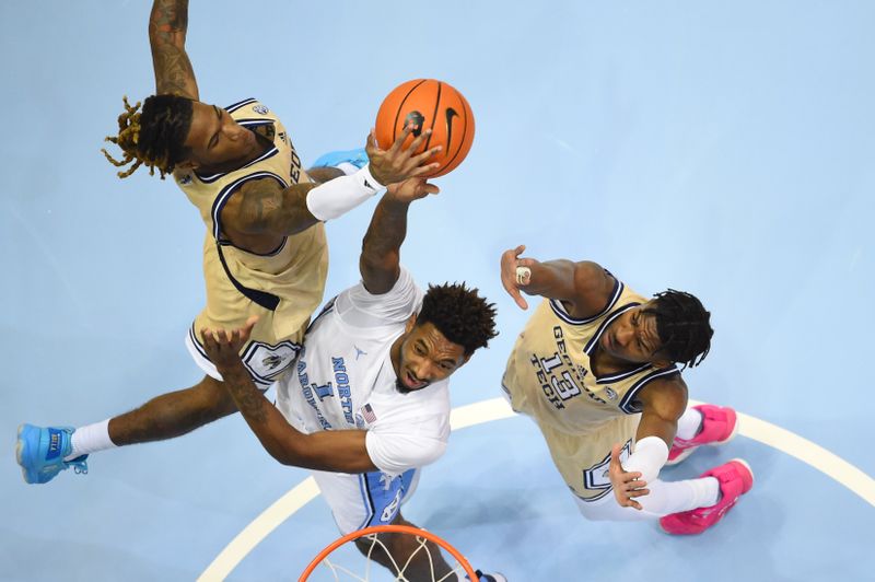 Dec 10, 2022; Chapel Hill, North Carolina, USA; North Carolina Tar Heels forward Leaky Black (1) has his shot blocked by Georgia Tech Yellow Jackets guard Deivon Smith (5) as guard Miles Kelly (13) helps defend in the first half at Dean E. Smith Center. Mandatory Credit: Bob Donnan-USA TODAY Sports