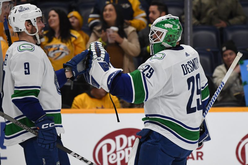 Dec 19, 2023; Nashville, Tennessee, USA; Vancouver Canucks goaltender Casey DeSmith (29) celebrates with Vancouver Canucks center J.T. Miller (9) after a win against the Nashville Predators at Bridgestone Arena. Mandatory Credit: Christopher Hanewinckel-USA TODAY Sports