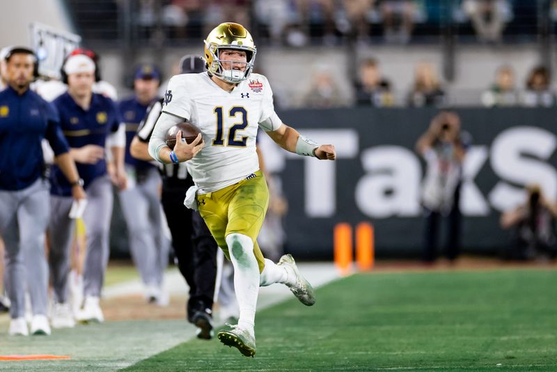 Dec 30, 2022; Jacksonville, FL, USA; Notre Dame Fighting Irish quarterback Tyler Buchner (12) runs with the ball to the sideline during the second half against the South Carolina Gamecocks in the 2022 Gator Bowl at TIAA Bank Field. Mandatory Credit: Matt Pendleton-USA TODAY Sports