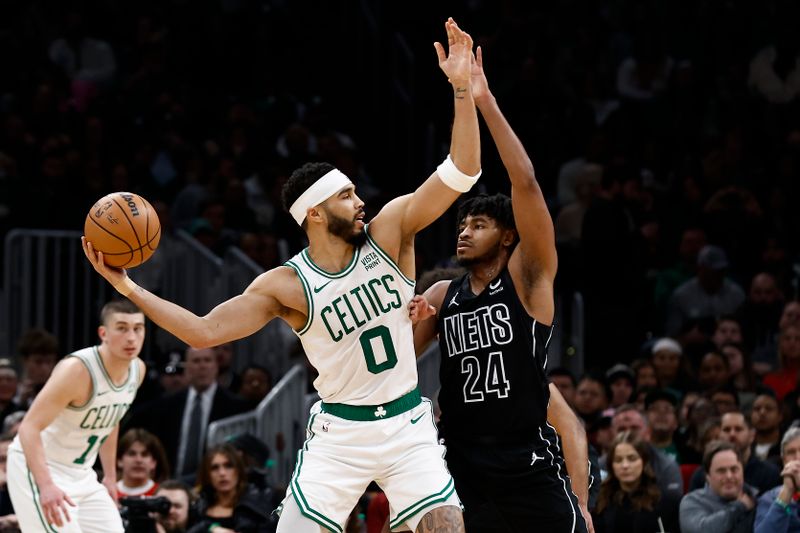 BOSTON, MA - FEBRUARY 14: Jayson Tatum #0 of the Boston Celtics fends off Cam Thomas #24 of the Brooklyn Nets during the second half at TD Garden on February 14, 2024 in Boston, Massachusetts. NOTE TO USER: User expressly acknowledges and agrees that, by downloading and/or using this Photograph, user is consenting to the terms and conditions of the Getty Images License Agreement. (Photo By Winslow Townson/Getty Images)