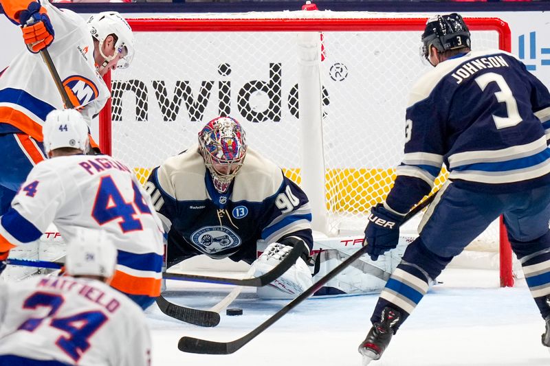 Oct 30, 2024; Columbus, Ohio, USA; Columbus Blue Jackets goaltender Elvis Merzlikins (90) blocks a shot in the second period against the New York Islanders at Nationwide Arena. Mandatory Credit: Samantha Madar-Imagn Images