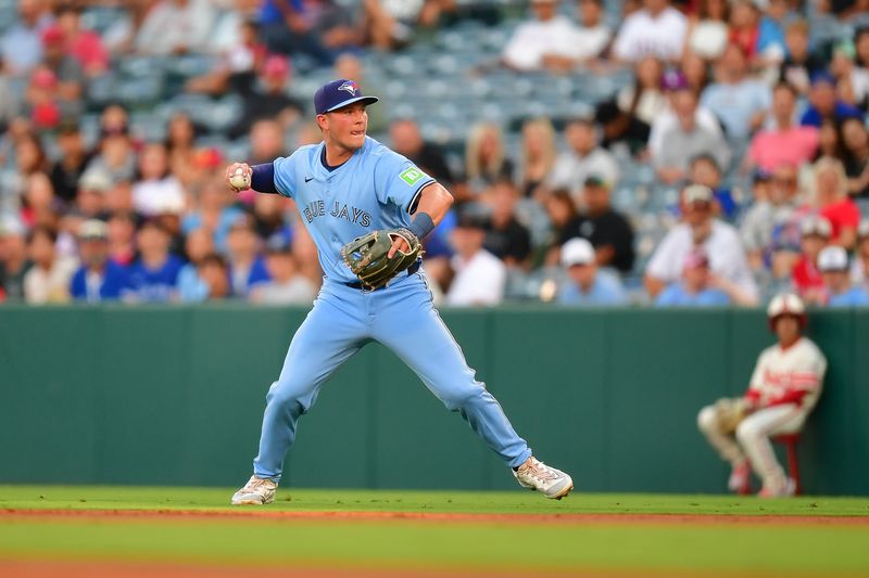 Aug 12, 2024; Anaheim, California, USA; Toronto Blue Jays second baseman Will Wagner (7) throws to first for the out against Los Angeles Angels designated hitter Willie Calhoun (5) during the second inning at Angel Stadium. Mandatory Credit: Gary A. Vasquez-USA TODAY Sports