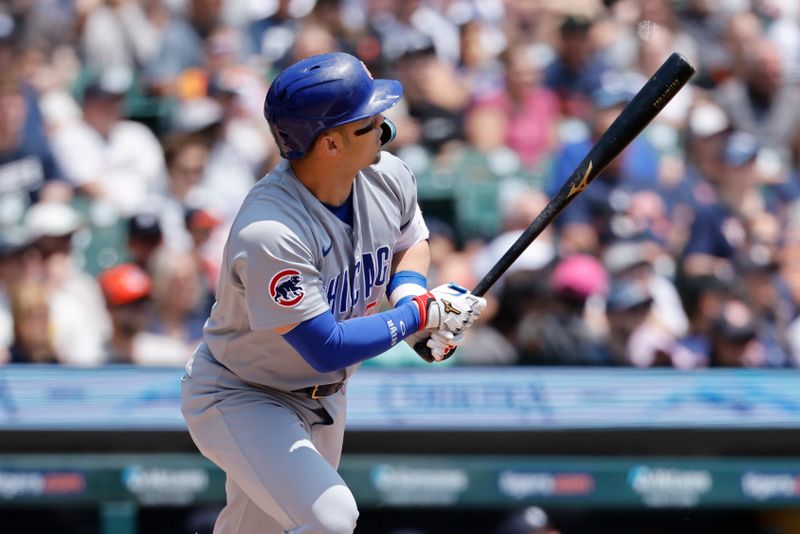 Jun 7, 2025; Detroit, Michigan, USA;  Chicago Cubs outfielder Seiya Suzuki (27) hits a home run in the first inning against the Detroit Tigers at Comerica Park. Mandatory Credit: Rick Osentoski-Imagn Images