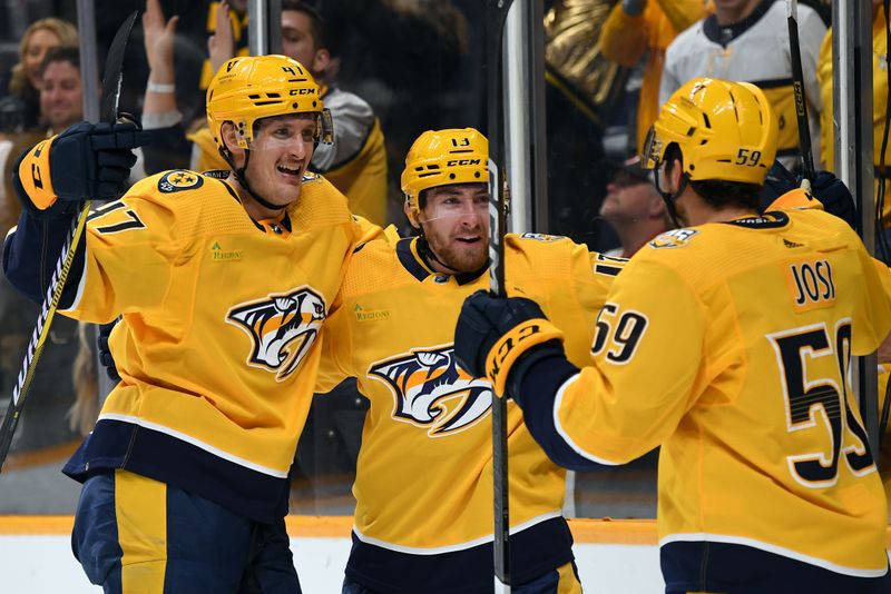 Nov 26, 2023; Nashville, Tennessee, USA; Nashville Predators center Yakov Trenin (13), right wing Michael McCarron (47), and defenseman Roman Josi (59) celebrate after a goal during the first period against the Winnipeg Jets at Bridgestone Arena. Mandatory Credit: Christopher Hanewinckel-USA TODAY Sports