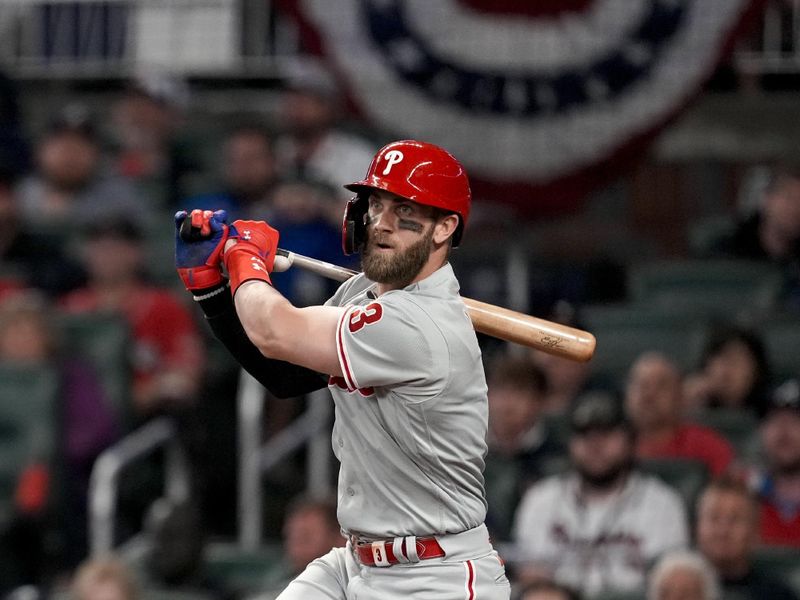 Oct 12, 2022; Atlanta, Georgia, USA; Philadelphia Phillies designated hitter Bryce Harper (3) watches his double against the Atlanta Braves in the second inning during game two of the NLDS for the 2022 MLB Playoffs at Truist Park. Mandatory Credit: Dale Zanine-USA TODAY Sports